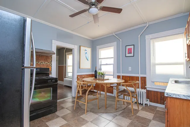 a view of a dining room with furniture and a window