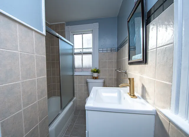 a bathroom with a sink a toilet and a shower