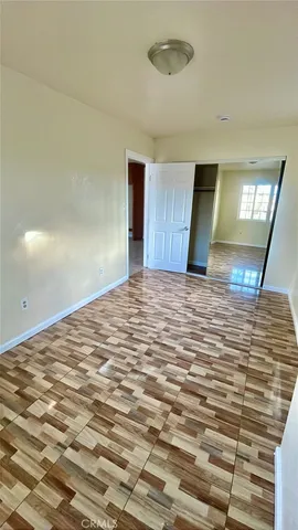 a view of a livingroom with wooden floor and a ceiling fan