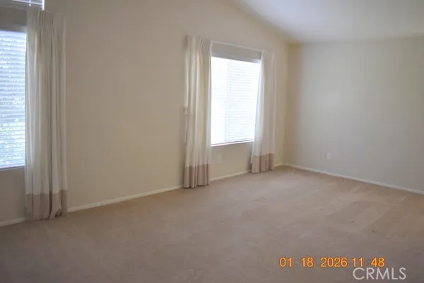 a view of an empty room and a window