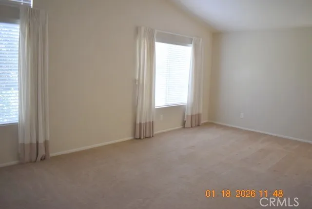 a view of an empty room and a window