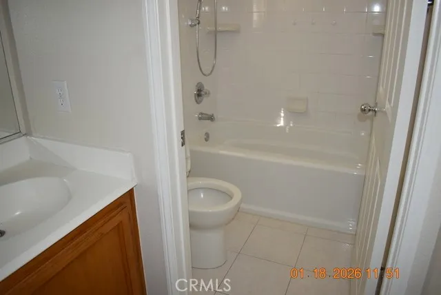 a bathroom with a granite countertop sink a toilet and shower