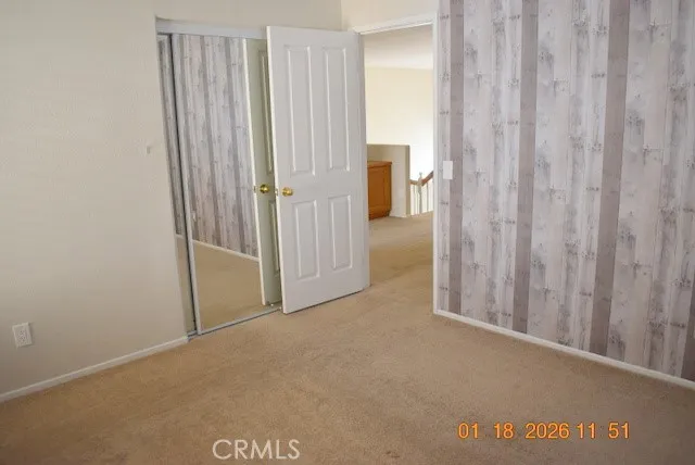 a view of a room with a wooden door