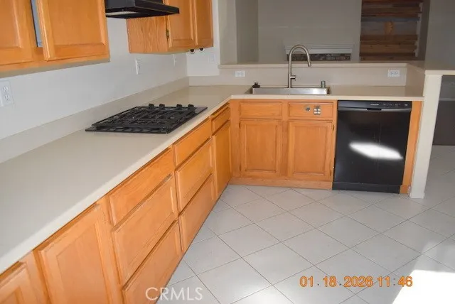 a kitchen with stainless steel appliances granite countertop a sink and cabinets with wooden floor