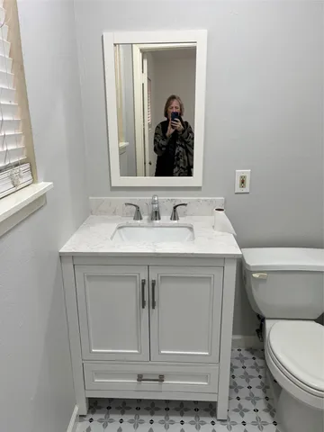 a bathroom with a sink toilet and mirror