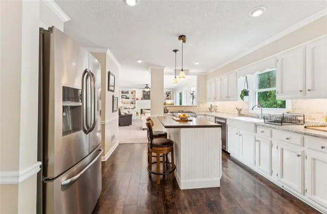 a kitchen with refrigerator cabinets and a sink