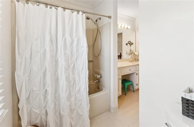a bathroom with a shower curtain and a sink