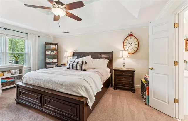a bedroom with bed and a chandelier