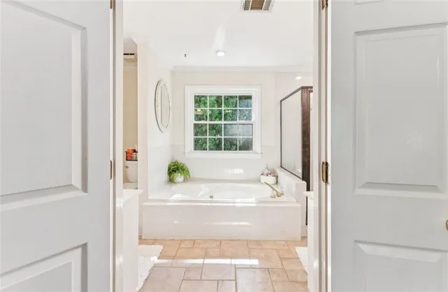 a bathroom with a bathtub and a shower