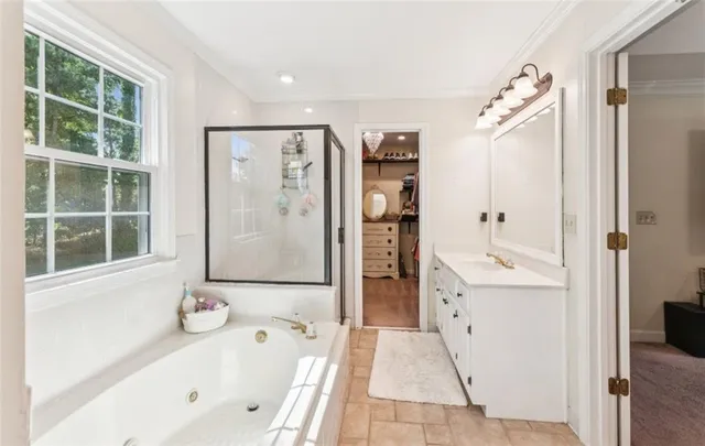 a bathroom with a tub sink and mirror
