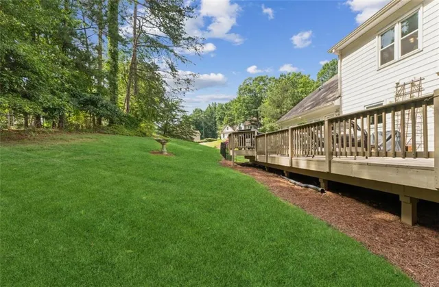 a view of a patio with a table chairs and backyard