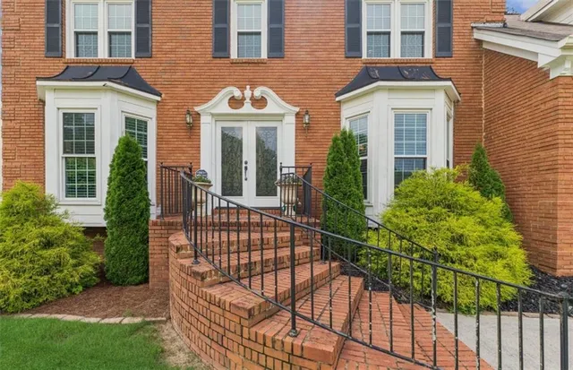 a view of a brick house with many windows