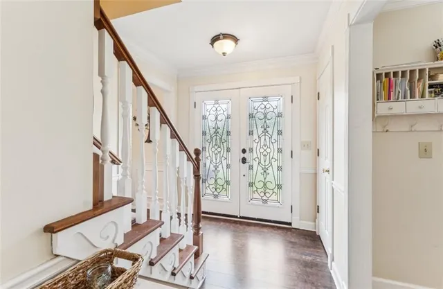 a view of an entryway with wooden floor and door