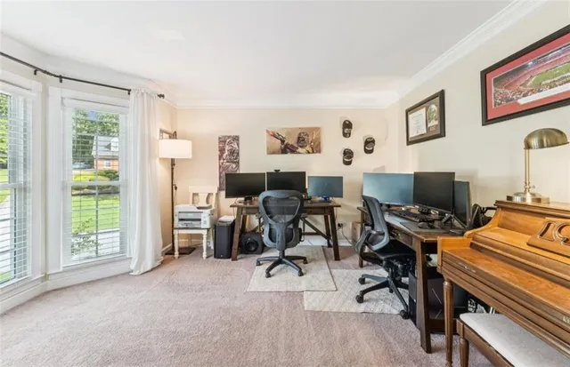 a view of a livingroom with workspace and a window
