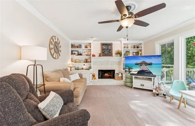 a living room with furniture a chandelier and a fireplace