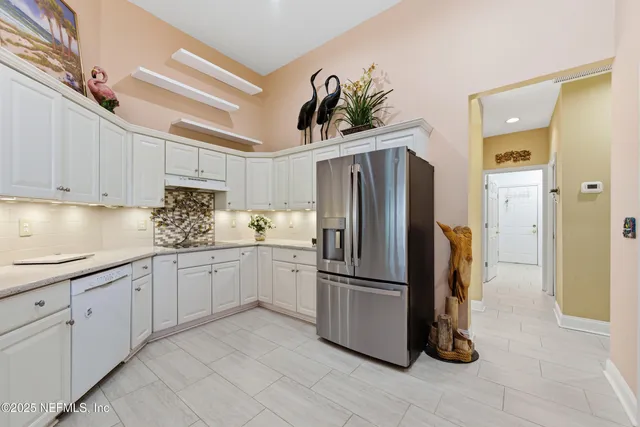 a kitchen with stainless steel appliances a sink and a refrigerator