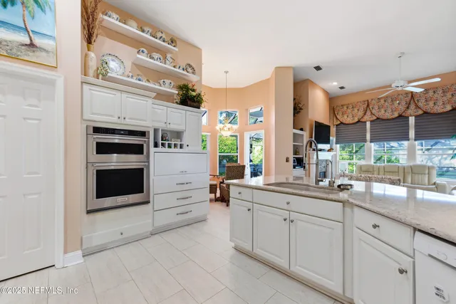 a view of a patio with a table chairs and backyard