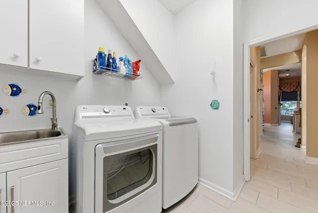a bedroom with double bed and a chandelier