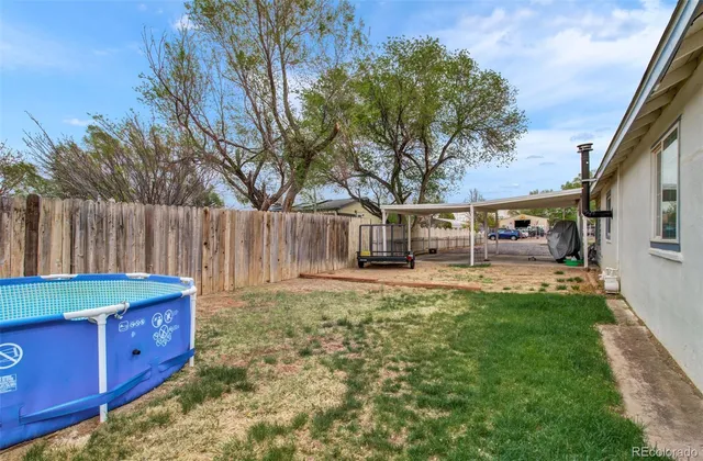 a view of a house with backyard and sitting area