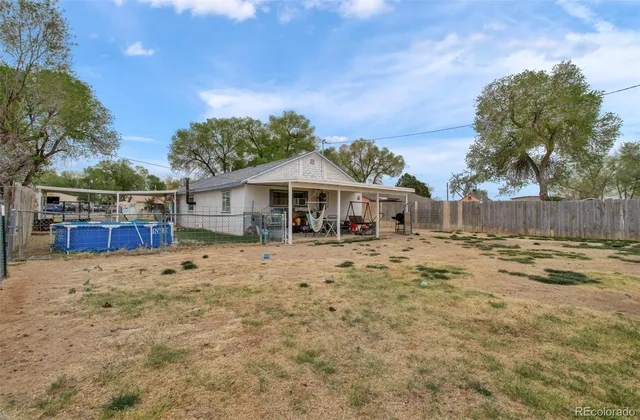a view of house with backyard and seating space