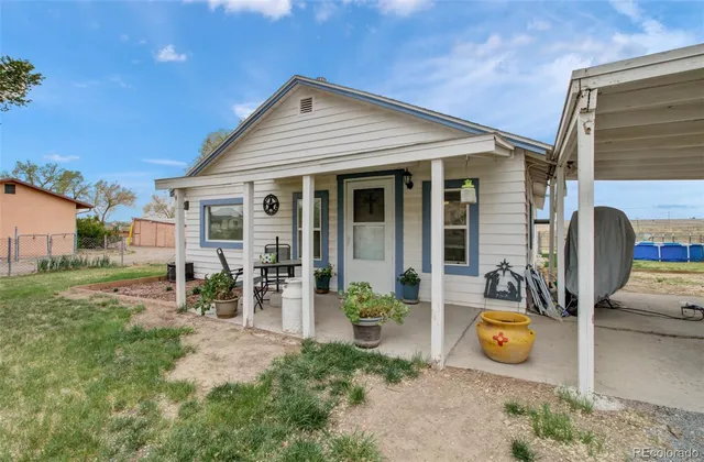 a view of a house with backyard sitting area and garden