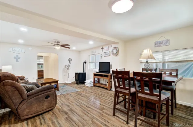 a living room with furniture a dining table and kitchen view