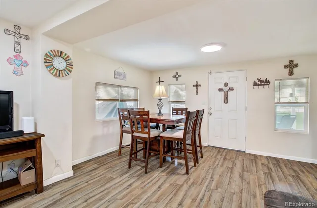 a view of a dining room with furniture and wooden floor