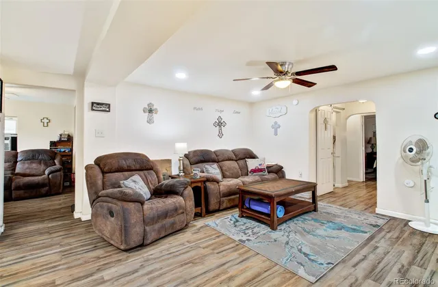 a living room with furniture and wooden floor