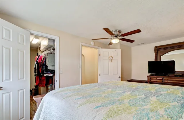 a bed room with a bed and a flat screen tv