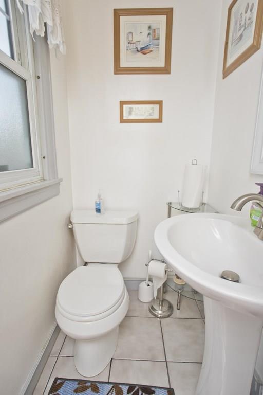 46 Thames Street Springfield, MA 01104 - Photo 11 of 12 a white toilet sitting next to a bathroom sink