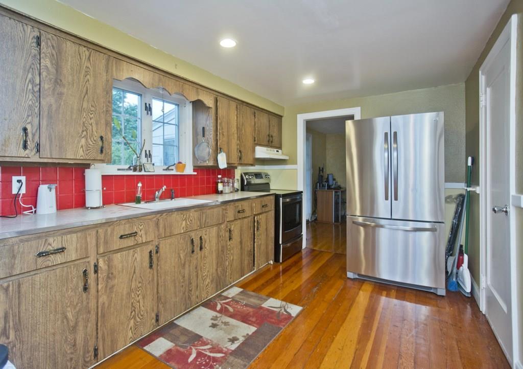 46 Thames Street Springfield, MA 01104 - Photo 3 of 12 a kitchen with a refrigerator wooden floor and window