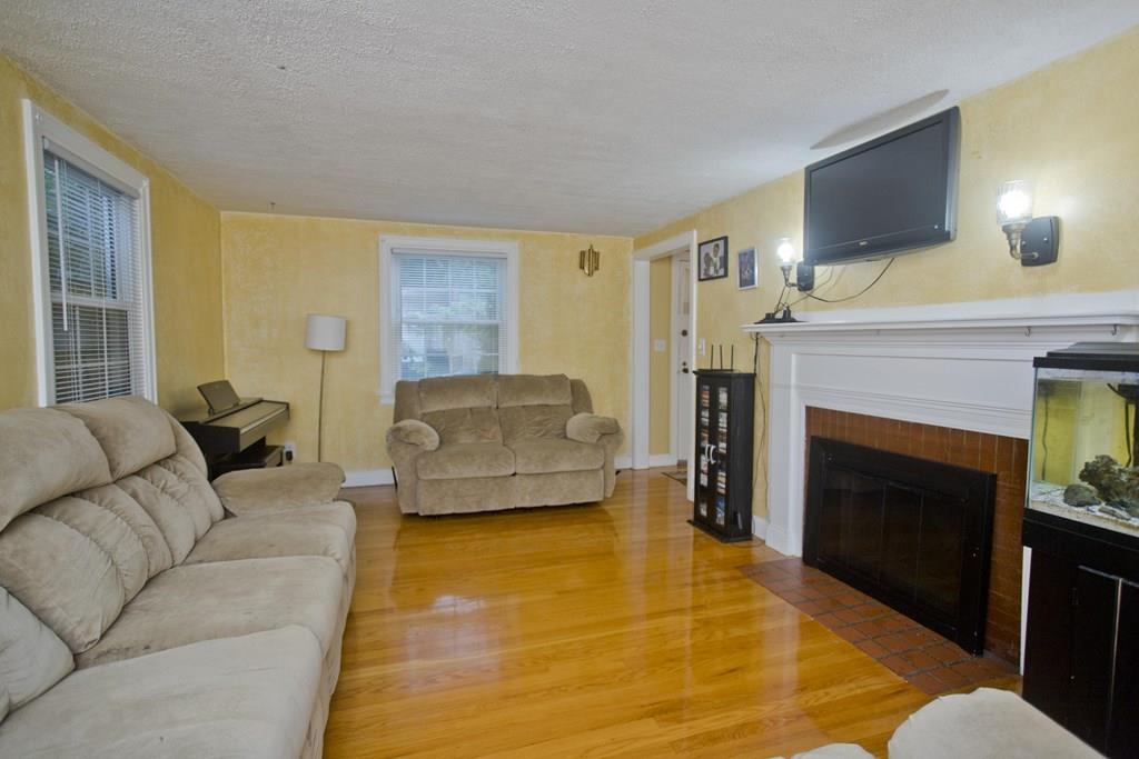 46 Thames Street Springfield, MA 01104 - Photo 5 of 12 a living room with furniture and a fireplace