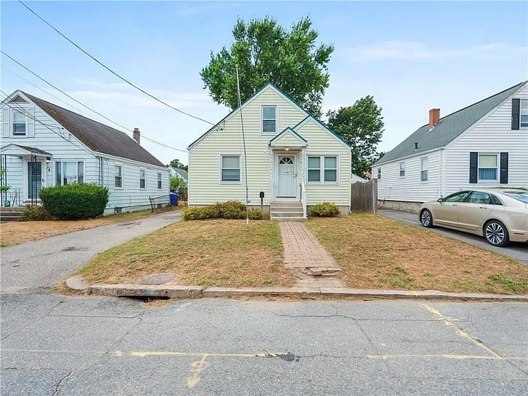 85 Manistee Street Pawtucket, RI 02861 - Photo 2 of 12 a view of a white house in front of a yard