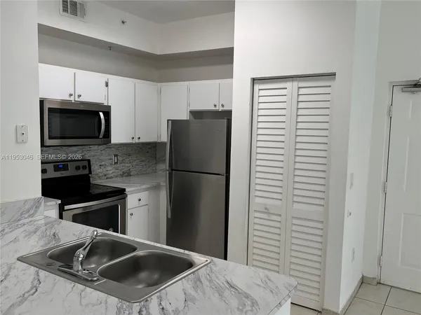 a kitchen with a refrigerator stove and microwave