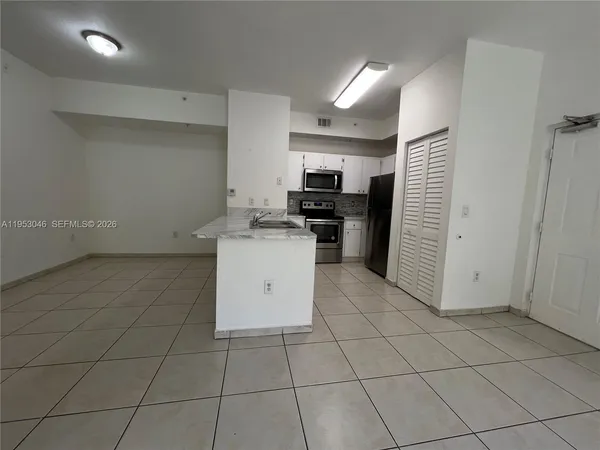 a kitchen with a sink a stove and refrigerator