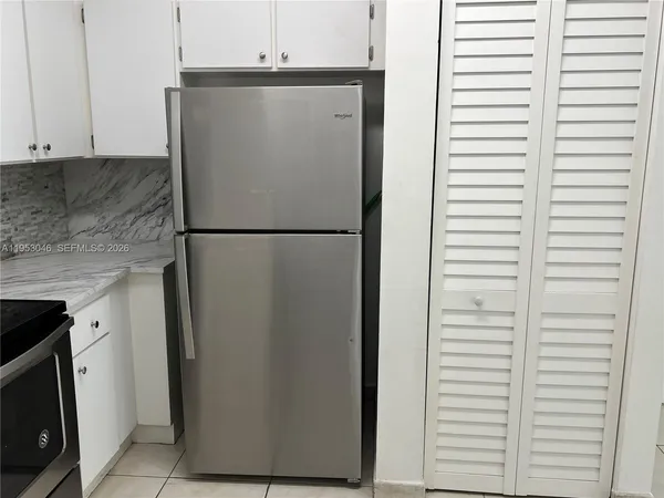 a white refrigerator freezer sitting inside of a kitchen