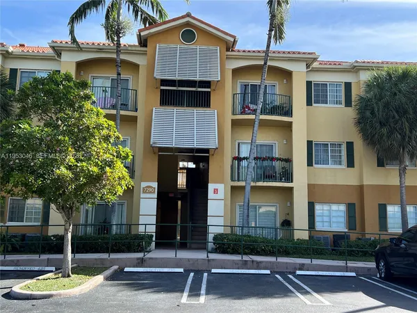 a front view of a residential apartment building with a yard