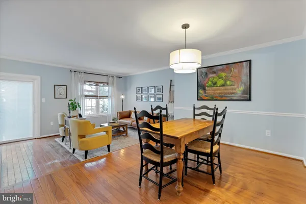 a dining room with furniture and wooden floor