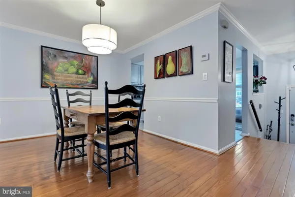 a view of a dining room with furniture wooden floor and chandelier
