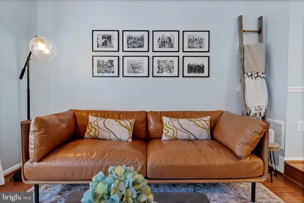 a blue couch sitting in a living room with a rug