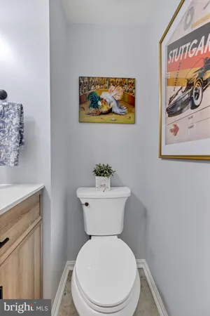 a white toilet sitting next to a bathroom sink