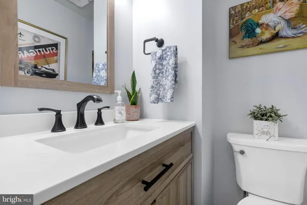 a bathroom with a sink a toilet and a mirror
