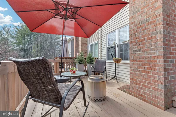 a view of a patio with table and chairs under an umbrella