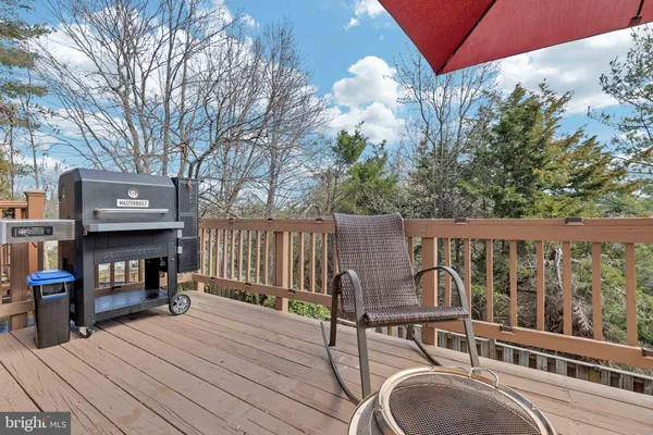 a view of a deck with wooden floor and iron fence