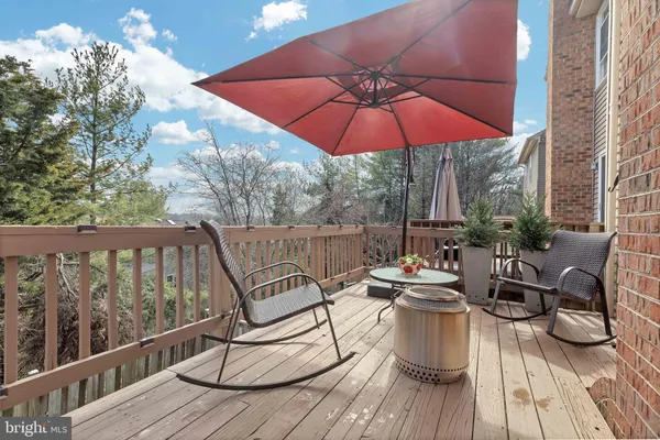 a view of a balcony with chairs and wooden floor