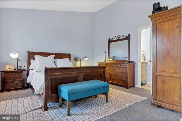a bedroom with a bed closet and wooden floor