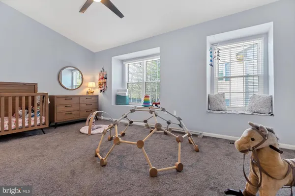 a living room with furniture a window and gym equipment