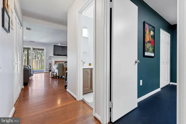a view of a livingroom with wooden floor and a bedroom