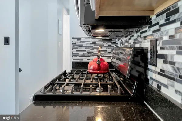 a kitchen with a stove and a sink