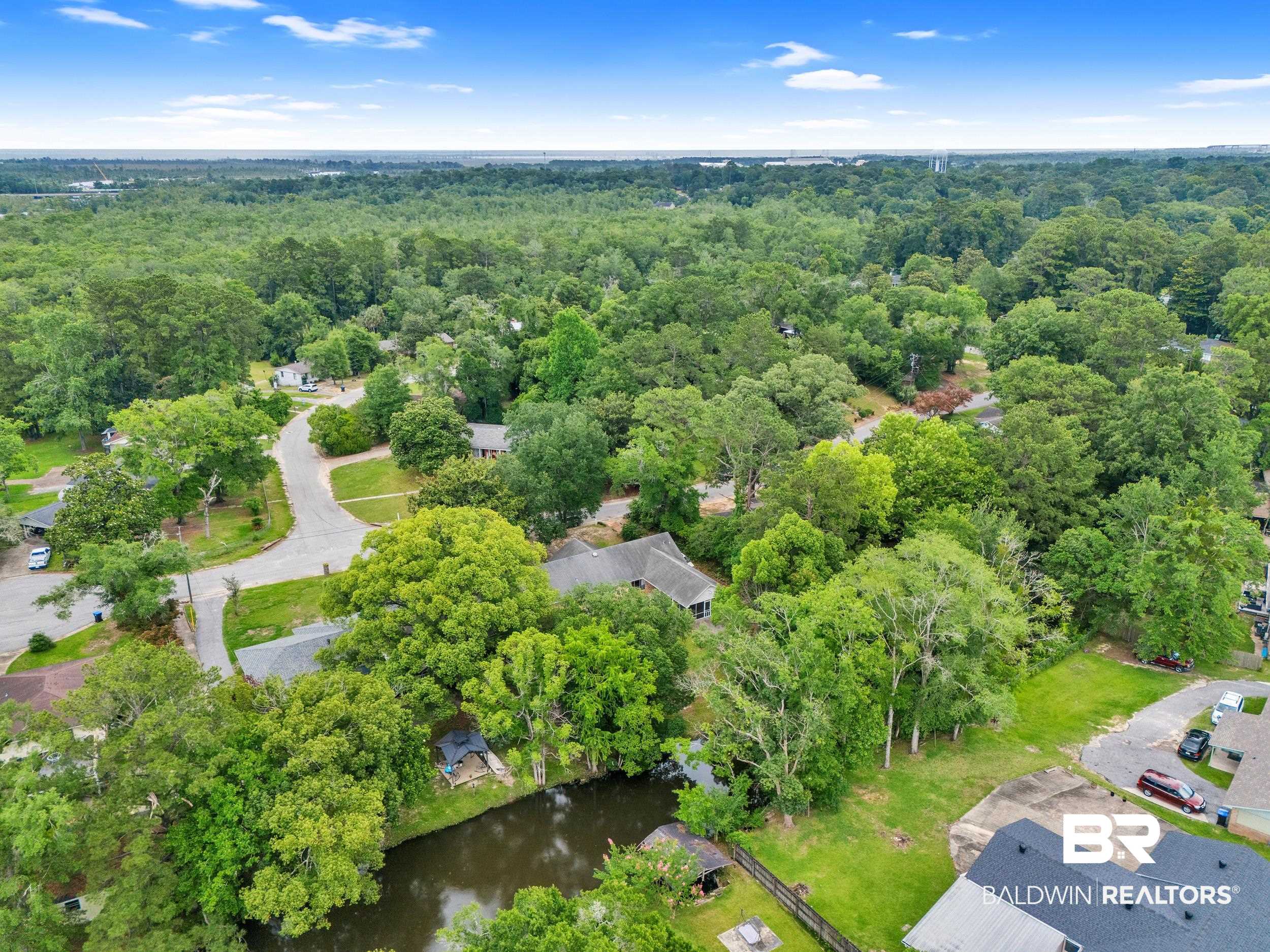 224 Cache Circle Mobile, AL 36611 - Photo 37 of 42 Aerial view of property and surrounding area featuring a heavily wooded area and a large body of water